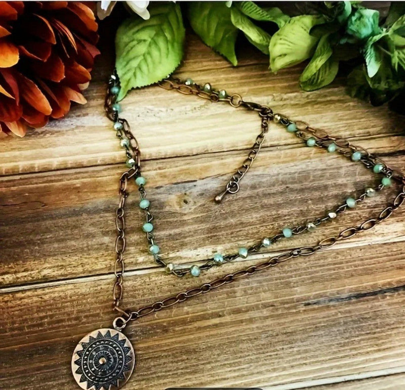 Beautiful 2 layer necklace featuring a sun pendant and turquoise beads