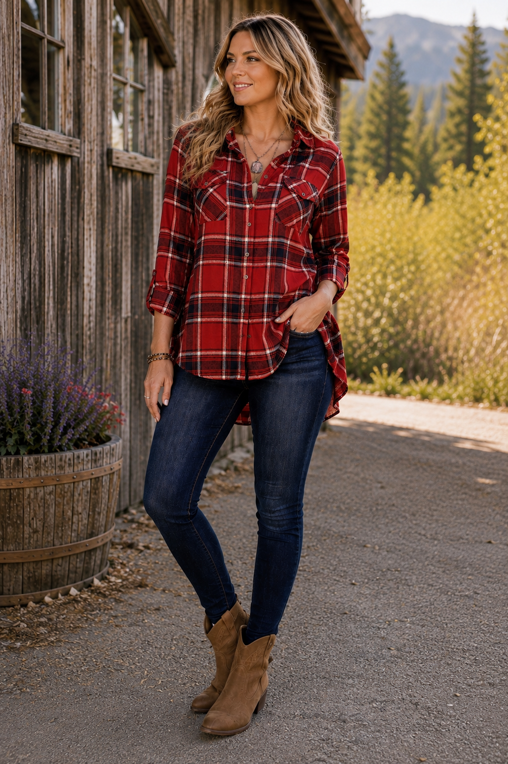 A woman stands outdoors in front of a rustic wooden building, wearing a red and black plaid button-up flannel shirt, dark blue skinny jeans, and tan ankle boots.