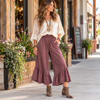 Woman wearing a bohemian lace top with the ruffle bottom mineral washed pants by Easel in Mulberry