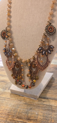 Handmade copper tone boho statement necklace with peach beads and layered fringe charms