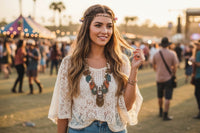 Woman wearing layered leaf boho statement necklace with white lace top