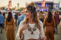 Woman wearing mixed charm boho statement necklace with cream crochet top