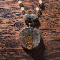 Close-up of Timekeeper necklace with intricate watch gears and floral detail