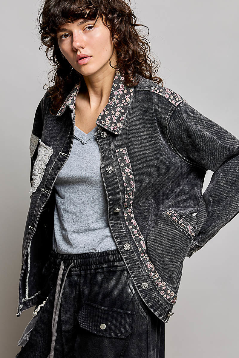 Model wearing a POL charcoal jacket with floral detail